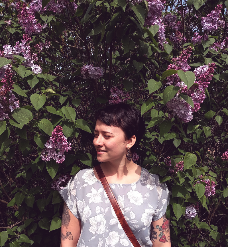 Michelle surrounded by beautiful lilac blossoms